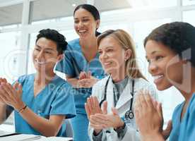 Every achievement deserves an applause. a group of doctors clapping hands in a meeting at work.