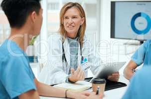 Their meetings are always a learning experience. a group of doctors in a meeting at a hospital.