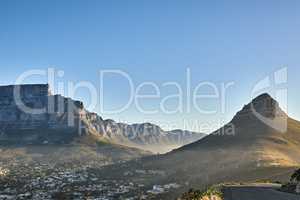 Mountain background, landscape of Table mountain and suburb with private houses against a blue sky background with copyspace. Beautiful view of vegetation surrounding city in Cape Town, South Africa
