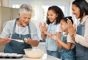 Gran is the expert at baking. a multi-generational family baking together at home.