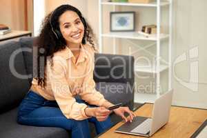 Today Im doing whatever I feel like. a woman holding a credit card while using her laptop.