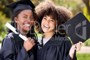 What a rad grad. Portrait of two young women celebrating their graduation.