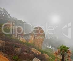 A misty morning on peaceful mountain peak, quiet zen nature with scenic views. Smog covered rocky landscape of Lions Head mountain. The aftermath of a devastating wildfire on a mountain.