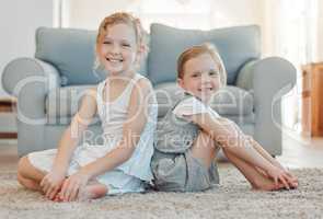 Guess whos got your back for life. two little girls bonding while sitting on the floor together at home.