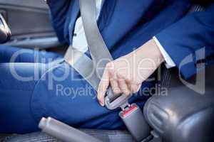 Its best to be as safe as you can. Closeup shot of an unidentifiable businessman fastening his seatbelt in a car.