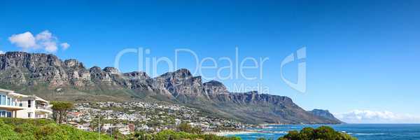 Twelve Apostles at Table Mountain in Cape Town against a blue sky background along the coast. Breathtaking panoramic of a peaceful suburb surrounded by a majestic valley, scenic nature and calm sea
