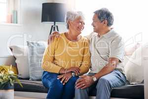 Her smile still makes me weak. a senior couple relaxing at home.