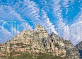 Majestic Table Mountain under cloudy blue sky copy space. Beautiful below view of a rocky peak covered in lush green vegetation at a popular travel and tourism destination in Cape Town, South Africa