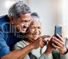 Look at that little face. a happy senior couple on a video call together at home.