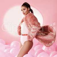 Shoot me in pink. Studio shot of a beautiful young woman posing with balloons.