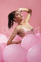 Paint me like one of your french girls. Studio shot of a beautiful young woman posing with balloons.