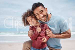 We simply love the beach. a man spending time at the beach with his son.