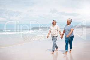 Nothing feels better than a walk on the beach. a senior couple taking a walk on the beach.