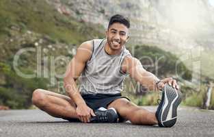 I can feel the difference after stretching. an athletic young man stretching on a mountain road.