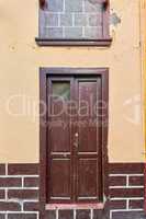 Old house or church with peeling paint on wall or window and wooden shutter door. Vintage and aged residential building built in a traditional architectural style or design in Santa Cruz de La Palma