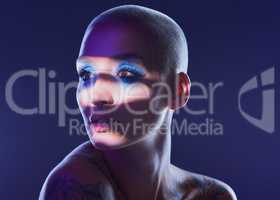 I rather be true to myself than hide my authenticity. Studio shot of an attractive young woman wearing edgy makeup against a blue background.