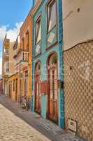 Scenic view of old historic houses, residential buildings, and traditional infrastructure in cobblestone city alleyways, streets, and roads. Tourism abroad and travel to Santa Cruz, La Palma, Spain