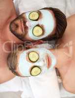 Relaxation is a stepping Stone to tranquility. a young couple wearing cucumbers on their eyes in a spa.