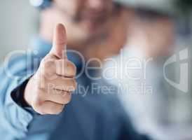 Its genuinely pleasing when customers are satisfied with your service. Closeup shot of an unrecognisable call centre agent showing thumbs up in an office.