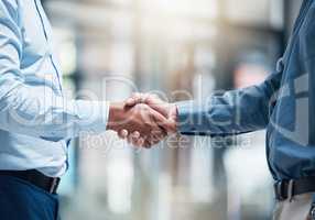 Id just like to say congratulations. two unrecognizable businesspeople shaking hands in an office at work.