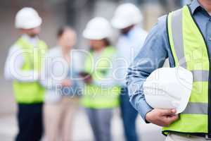 We put safety first. an unrecognizable architect holding a helmet at a building site.