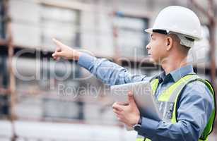 Whats that over there. a mature male architect using a digital tablet at a building site.