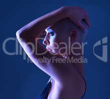 There is beauty in uniqueness. Studio shot of an attractive young woman wearing edgy makeup against a blue background.