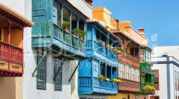 Old buildings in a city built by traditional architecture in a small town or village. Home or flats with a vintage design close to each other outdoors with a blue sky in Santa Cruz de La Palma