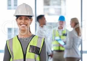 To build something brings me great joy. Cropped portrait of an attractive young female construction with her colleagues in the background.