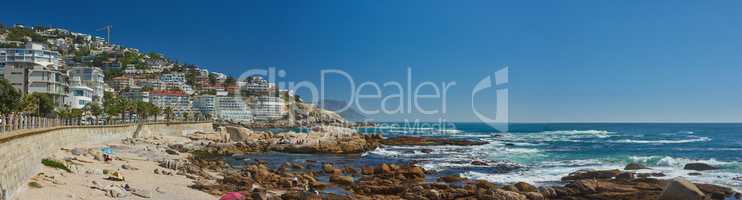 Landscape of Clifton Beach with a blue sky and copy space in Cape Town, South Africa. Luxury accommodation and holiday apartment buildings with scenic ocean views. Popular tourism summer destination