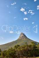 The majestic, wonderful and beautiful Lions Head mountain from below. Blue sky copy space over mountainous landscape terrain in Cape Town, South Africa. Lush green flora in a protected nature reserve