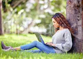 Breaks are just more time for learning. Full length shot of an attractive young female student using her laptop to study outside on campus.