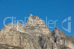 Landscape view of Table Mountain in Cape Town, South Africa with blue sky and copy space. Low angle of a steep, rough and rugged famous hiking terrain. Risky and dangerous challenge to climb the peak