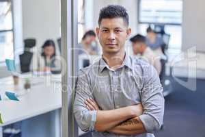 I lead a great team. a mature businessman standing with his arms crossed in an office at work.