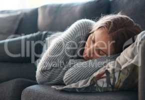 Life can be so bleak. Shot of a young woman lying on her couch feeling depressed.