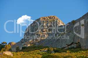 Landscape of Lions Head mountain in Cape Town, South Africa in summer. Rock texture on a hill or mountain peak in a remote hiking area against blue sky.