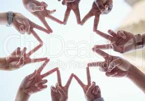 Spreading peace is far more beneficial. a group of business people with their hands in a star shape.