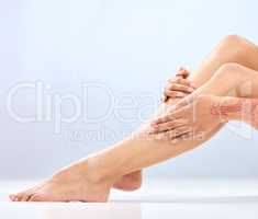 Is your skin ever ready for those harsh blades. an unrecognizable womans legs in studio against a blue background.