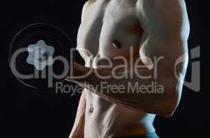 Get ripped with every rep. Studio shot of an unrecognisable man lifting weights against a dark background.