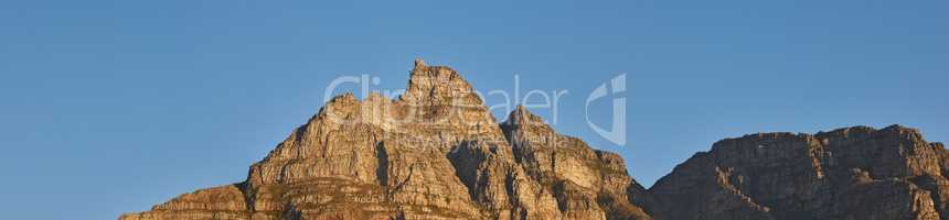 Copy space with scenic landscape view of Table Mountain in Cape Town, South Africa against a clear blue sky background. Majestic panoramic view of an iconic landmark and famous travel destination