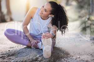 Stretching is actually quite relaxing. a sporty young woman stretching on the ground.