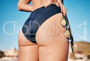 I always try to just focus on what Im doing. a unrecognizable female standing with her goggles after a swim outside.