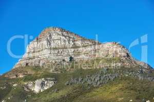Beautiful Lions Head mountain on clear blue sky with copy space. Summer landscape of mountains with hills covered in green grass or bushes at a tourism sightseeing location in Cape Town, South Africa