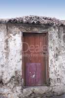 Frontal view of traditional building in Santa Cruz de La Palma. Close up of ancient declining hut on Spanish island. Wooden door remains in am old cottage in a remote uninhabited area.