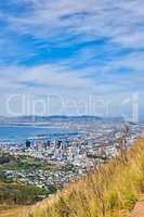 Landscape view of the city of Cape Town in South Africa. Beautiful scenic view of a popular tourist town with greenery and nature during summer. Ocean and residential in the Western Cape
