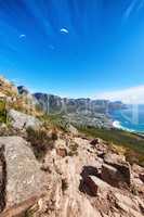 Sky divers paragliding over rocky mountain trail for tourists seeking a thrill is a great activity to explore when on holiday or vacation. Nature and ocean, blue sky background with copy space