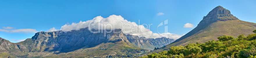 Panoramic landscape of Table Mountain and Lions Head in Cape Town, South Africa. Aerial view of a majestic and breathtaking blue sky background over a natural wilderness environment during summer