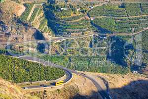 Beautiful landscape of a small agricultural village on a sunny afternoon near a highway or busy road for logistics or transport of goods. Banana plantations in the town Los Llanos, La Palma, Spain