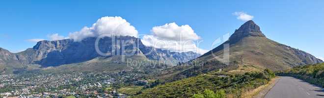 Copyspace with a mountain pass along Lions Head and Table Mountain in Cape Town, South Africa against a cloudy sky background over a peninsula. calm, scenic landscape to travel explore on a road trip