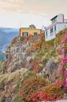 City view of residential buildings or houses on hill cliff in Santa Cruz, La Palma, Spain. Historical spanish, colonial architecture, vibrant flowers in tropical village of famous tourism destination